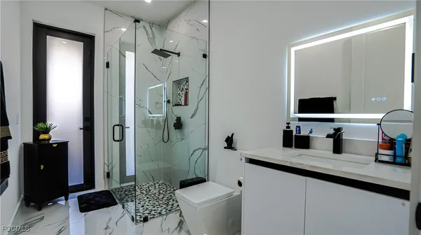a bathroom with a sink toilet and shower