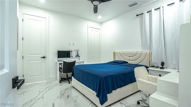 a bedroom with a bed and a chair