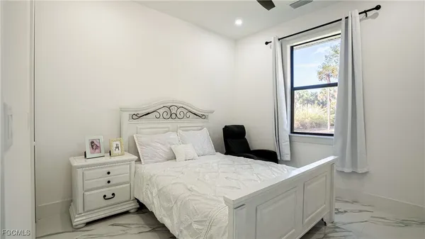 a bedroom with a bed and a chair