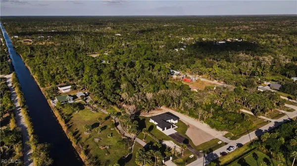 an aerial view of a house with a yard