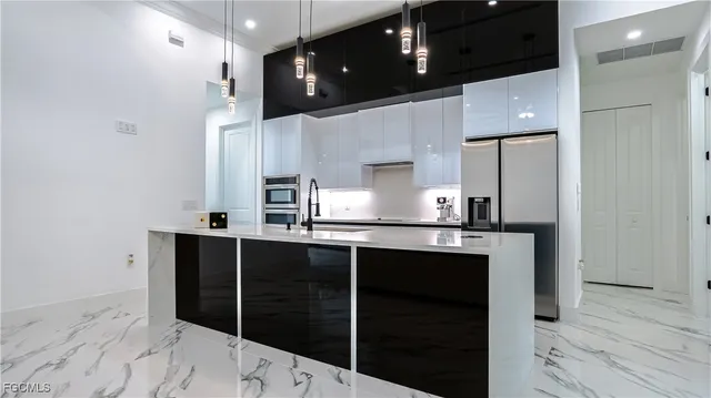 a kitchen with kitchen island granite countertop a sink and cabinets