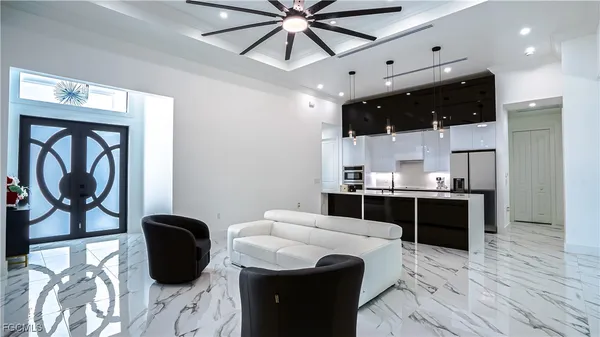 a kitchen with stainless steel appliances kitchen island granite countertop a sink a stove and cabinets