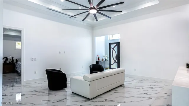 a living room with furniture and a ceiling fan