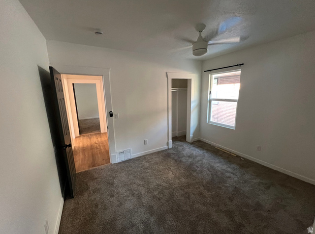 545 23rd Street Ogden, UT 84401 - Photo 11 of 28 Carpeted room featuring a ceiling fan, a window with a dark curtain rod, and a built-in closet with white trim
