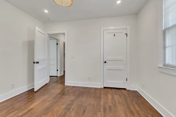 a view of a room with wooden floor and window
