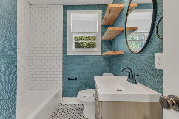 a bathroom with a toilet sink and mirror
