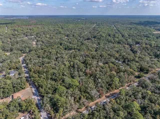 a view of a yard with wooden fence