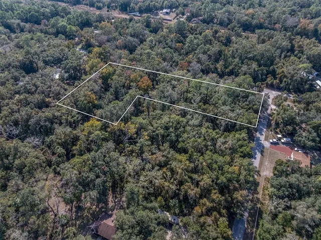 an aerial view of house with yard