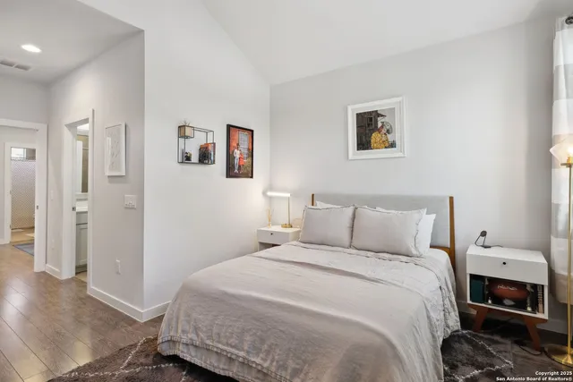 a bedroom with a bed and a lamp