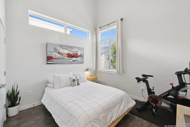 a bedroom with a bed and a painting on the wall