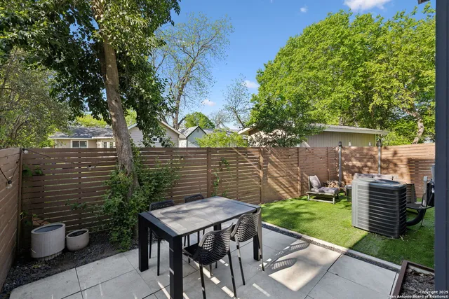 a view of a chairs and table in backyard of the house
