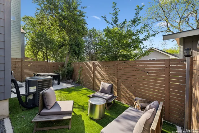 a view of a patio with chairs next to a yard