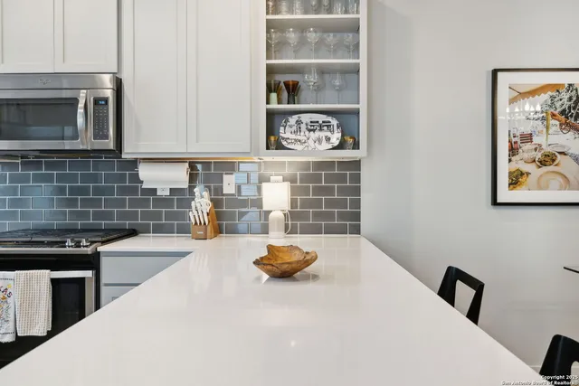 a bedroom with a bed and a microwave