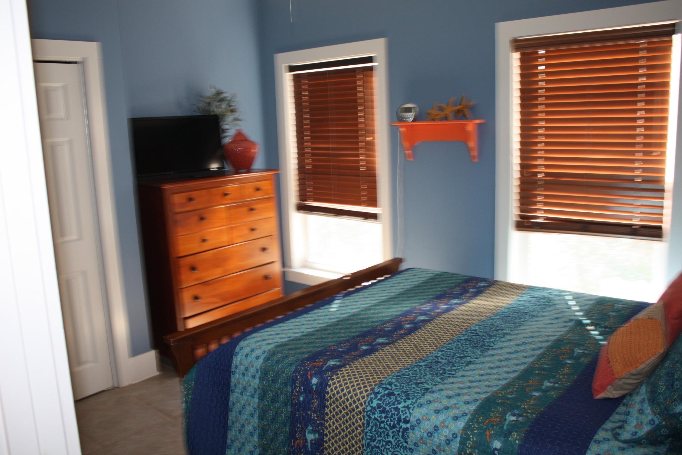 516 Hidden Lake Way Santa Rosa Beach, FL 32459 - Photo 15 of 24 a bedroom with a bed and a flat tv screen
