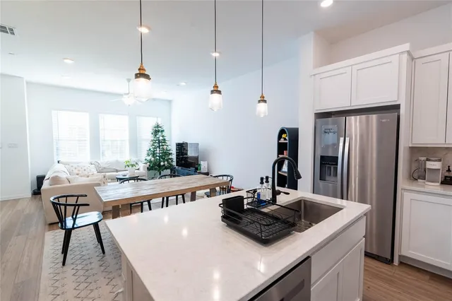 a kitchen with a stove a refrigerator and a dining table