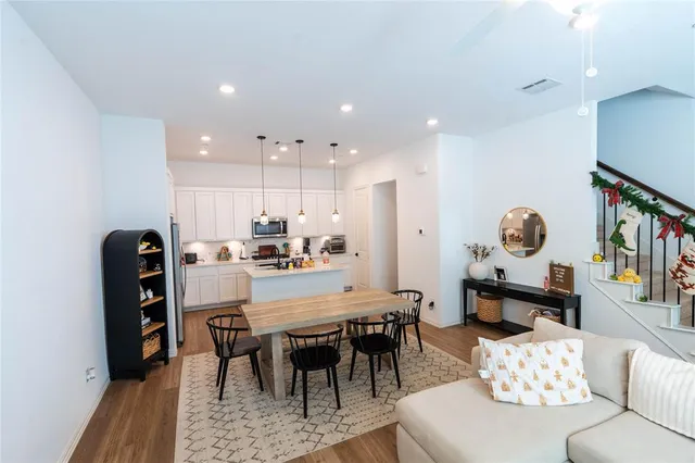 a dining room with furniture and a window