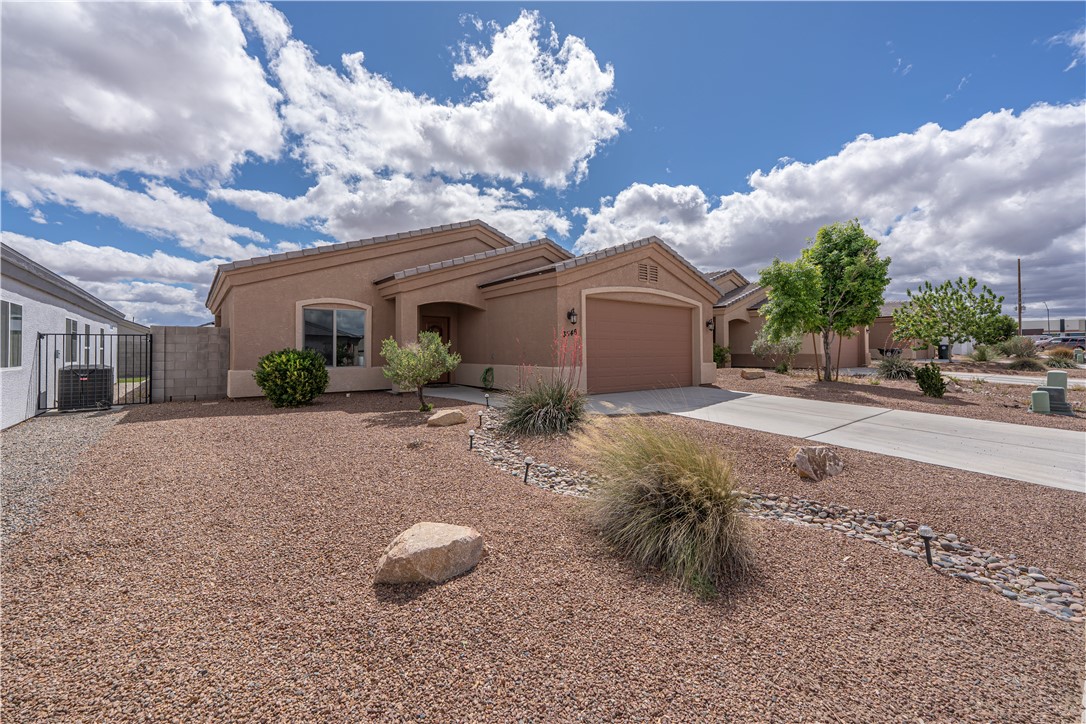 3546 North Kenneth Road Kingman, AZ 86409 - Photo 29 of 35 The property features a stucco exterior, an attached garage, and a driveway