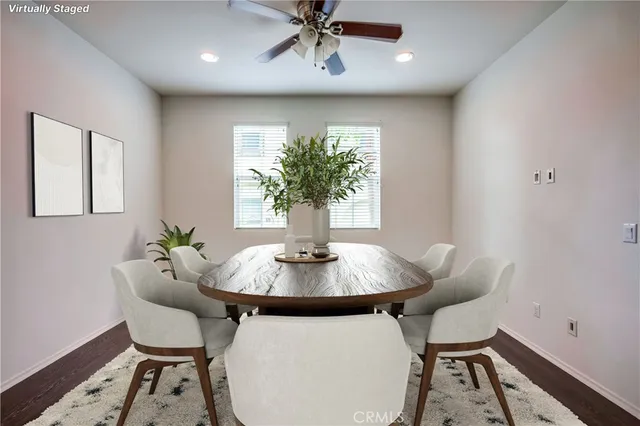 a living room with furniture a large window and kitchen view