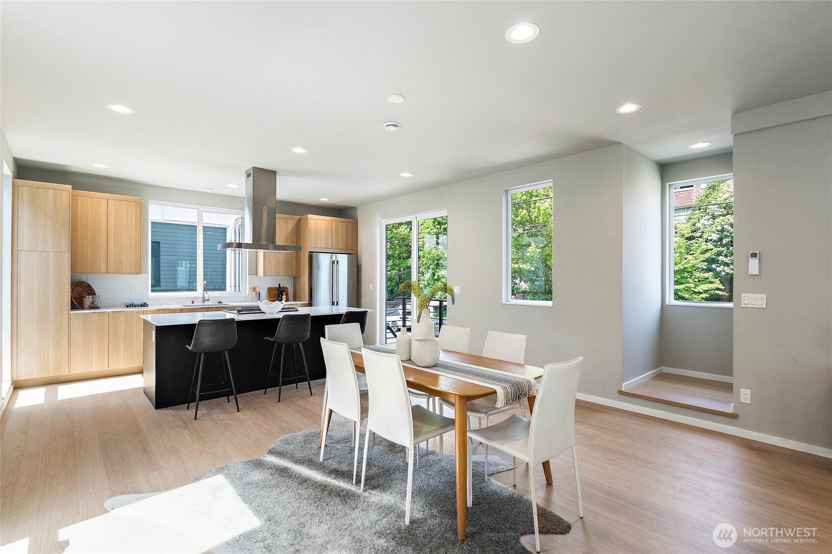 1801 Northwest 65th Street, Unit C Seattle, WA 98117 - Photo 14 of 40 a kitchen with a table and chairs in it