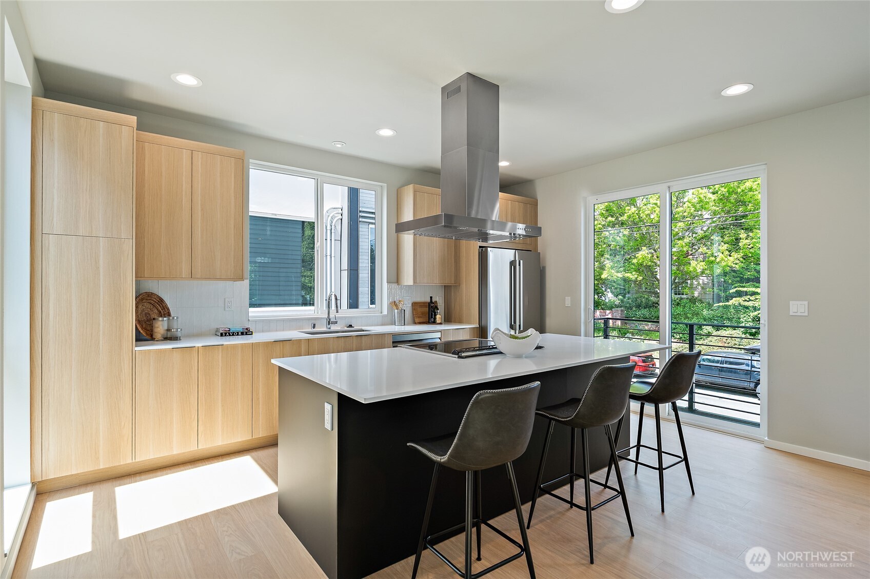 1801 Northwest 65th Street, Unit C Seattle, WA 98117 - Photo 14 of 39 a dining hall with stainless steel appliances granite countertop wooden floor a center island and furniture