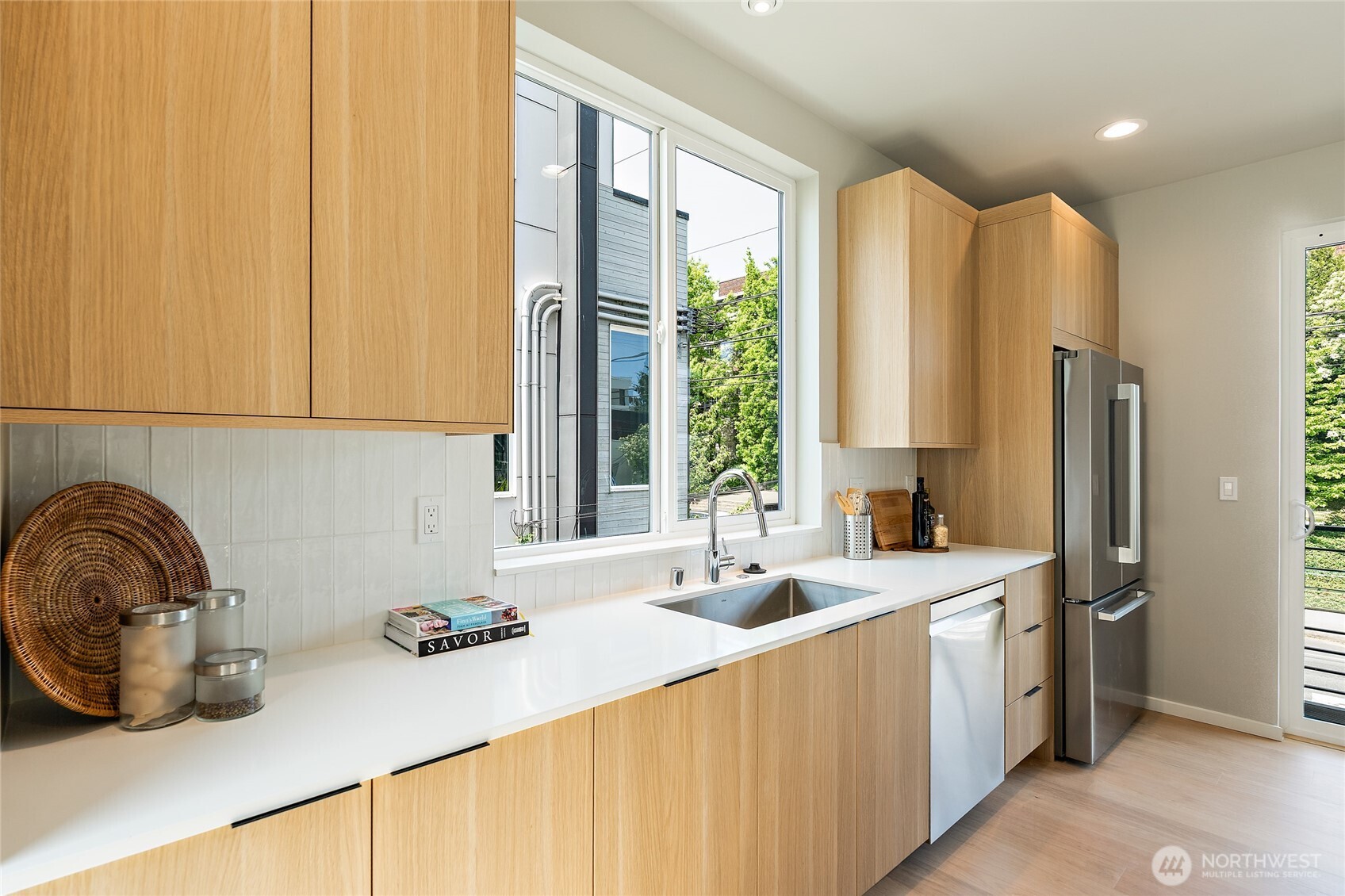 1801 Northwest 65th Street, Unit C Seattle, WA 98117 - Photo 17 of 39 a kitchen with sink a window and cabinets