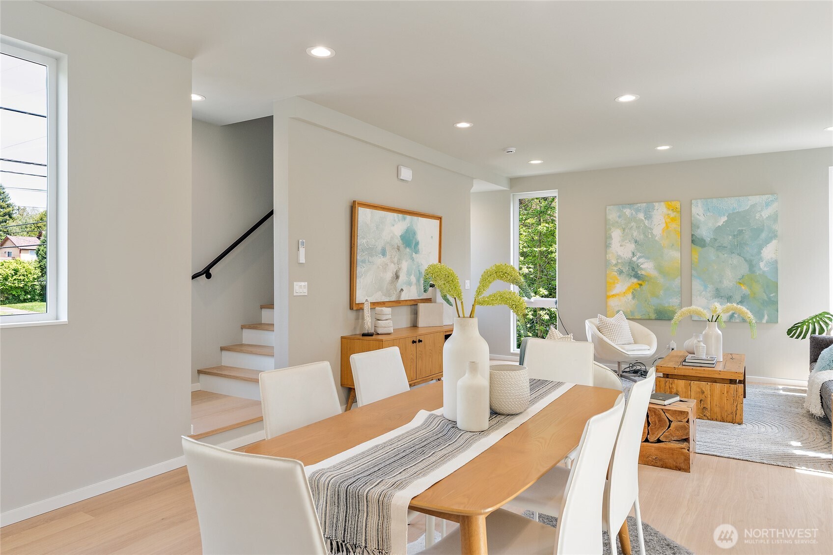 1801 Northwest 65th Street, Unit C Seattle, WA 98117 - Photo 21 of 40 a view of a dining room with furniture a potted plant and wooden floor