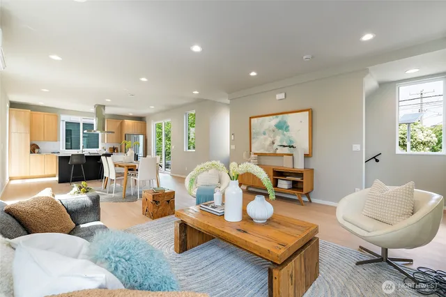 a living room with furniture and kitchen view