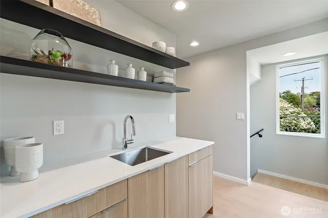 a kitchen with a sink a stove and cabinets