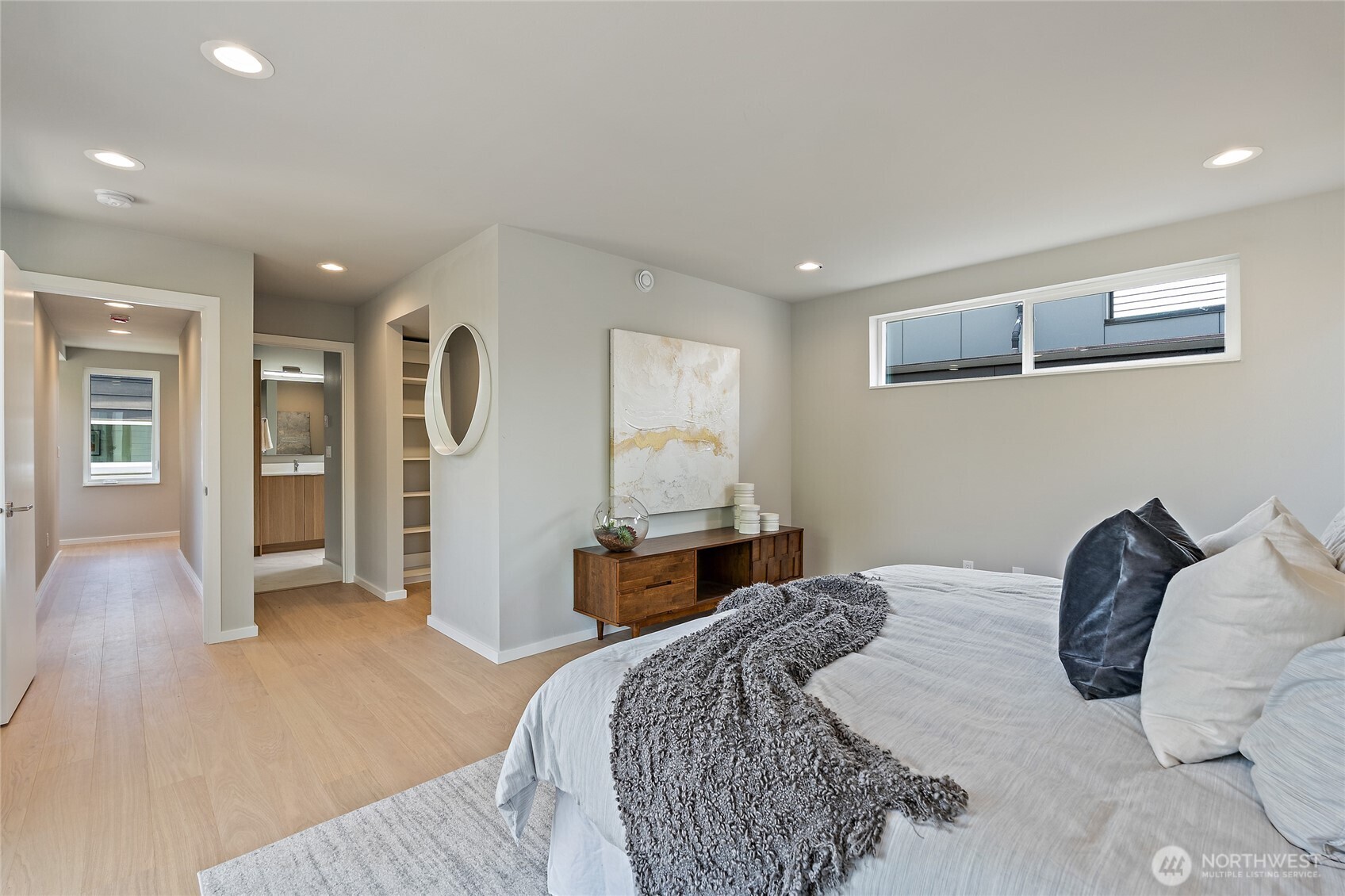 1801 Northwest 65th Street, Unit C Seattle, WA 98117 - Photo 29 of 40 a bedroom with a large bed and wooden floor