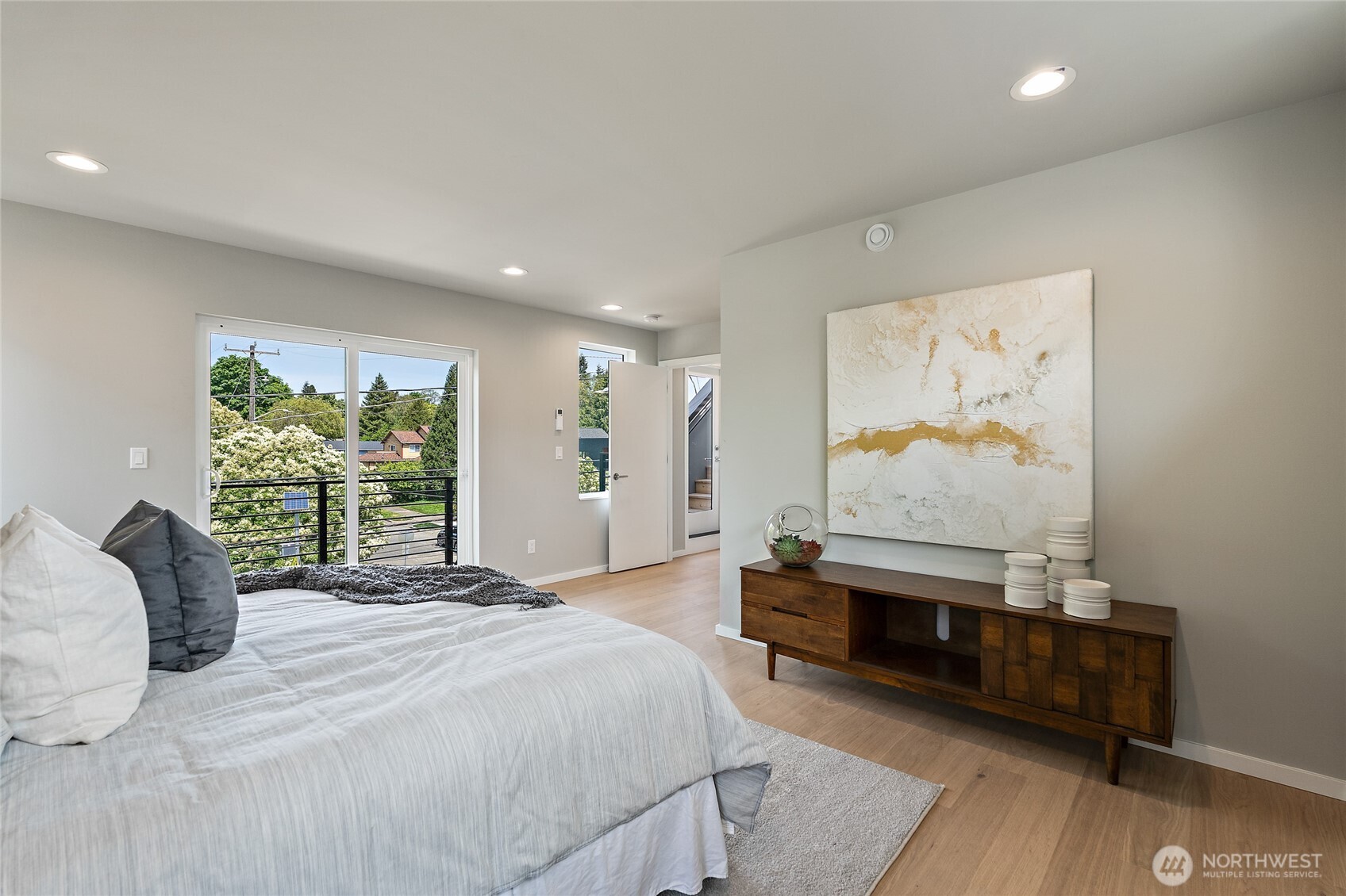 1801 Northwest 65th Street, Unit C Seattle, WA 98117 - Photo 29 of 39 a spacious bedroom with a bed and a large window