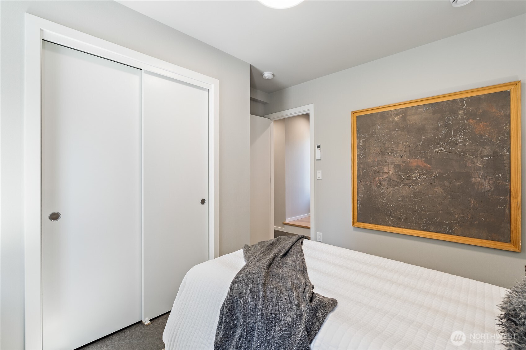 1801 Northwest 65th Street, Unit C Seattle, WA 98117 - Photo 3 of 39 a bedroom with a bed and a painting on the wall