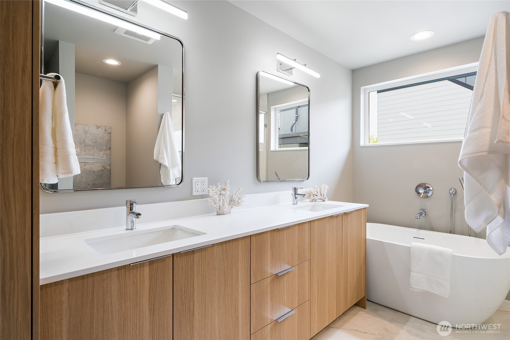 1801 Northwest 65th Street, Unit C Seattle, WA 98117 - Photo 32 of 39 a bathroom with a double vanity sink mirror and bathtub