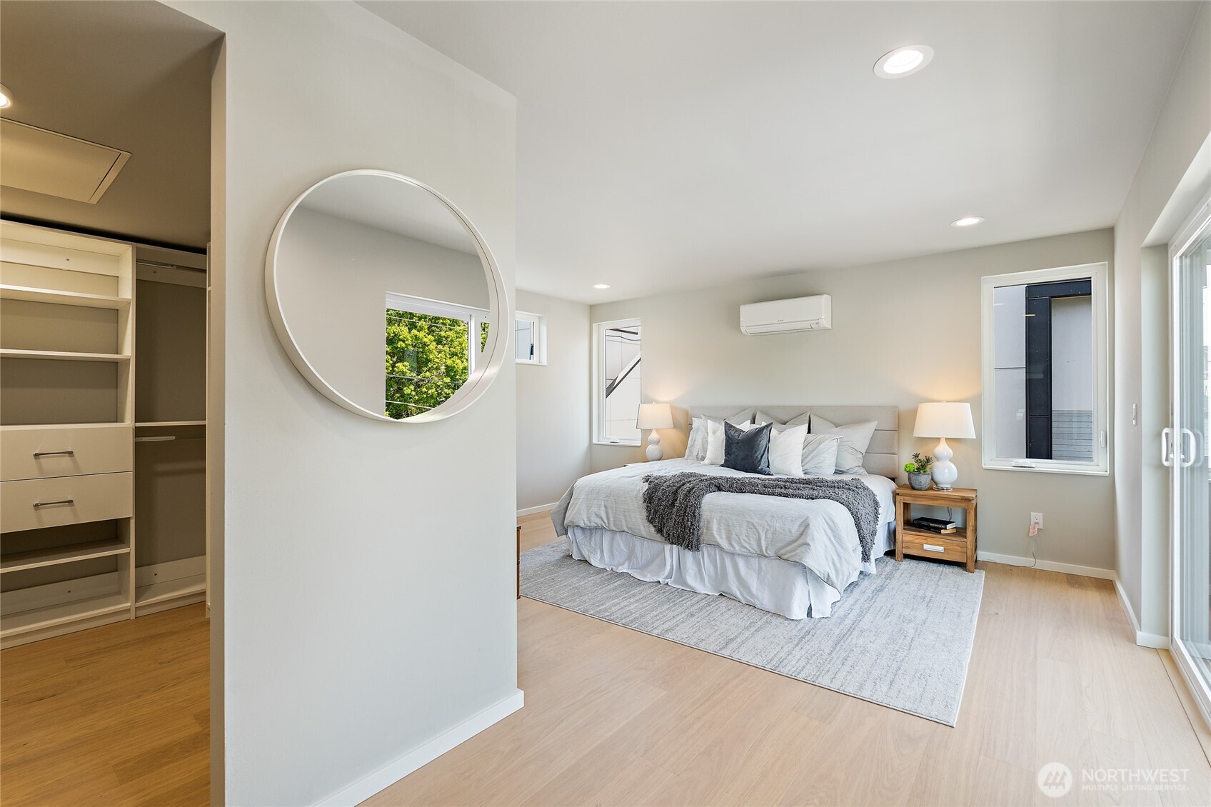 1801 Northwest 65th Street, Unit C Seattle, WA 98117 - Photo 32 of 40 a spacious bedroom with a bed and a mirror