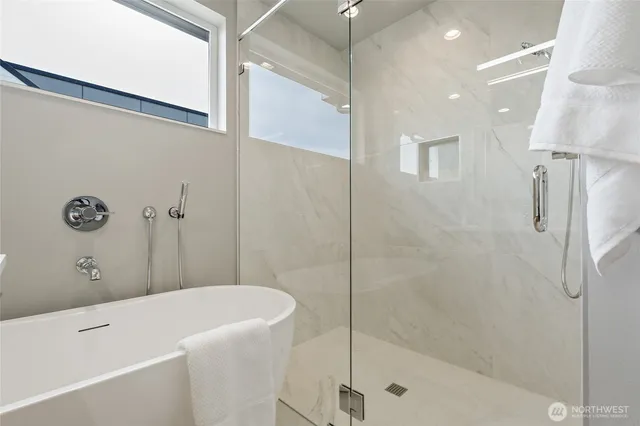 a bathroom with a bathtub and a shower