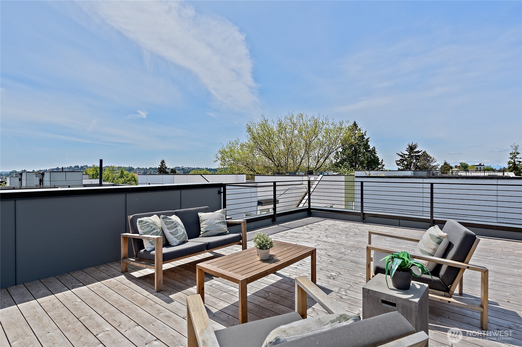 1801 Northwest 65th Street, Unit C Seattle, WA 98117 - Photo 38 of 40 a terrace with outdoor seating and trees