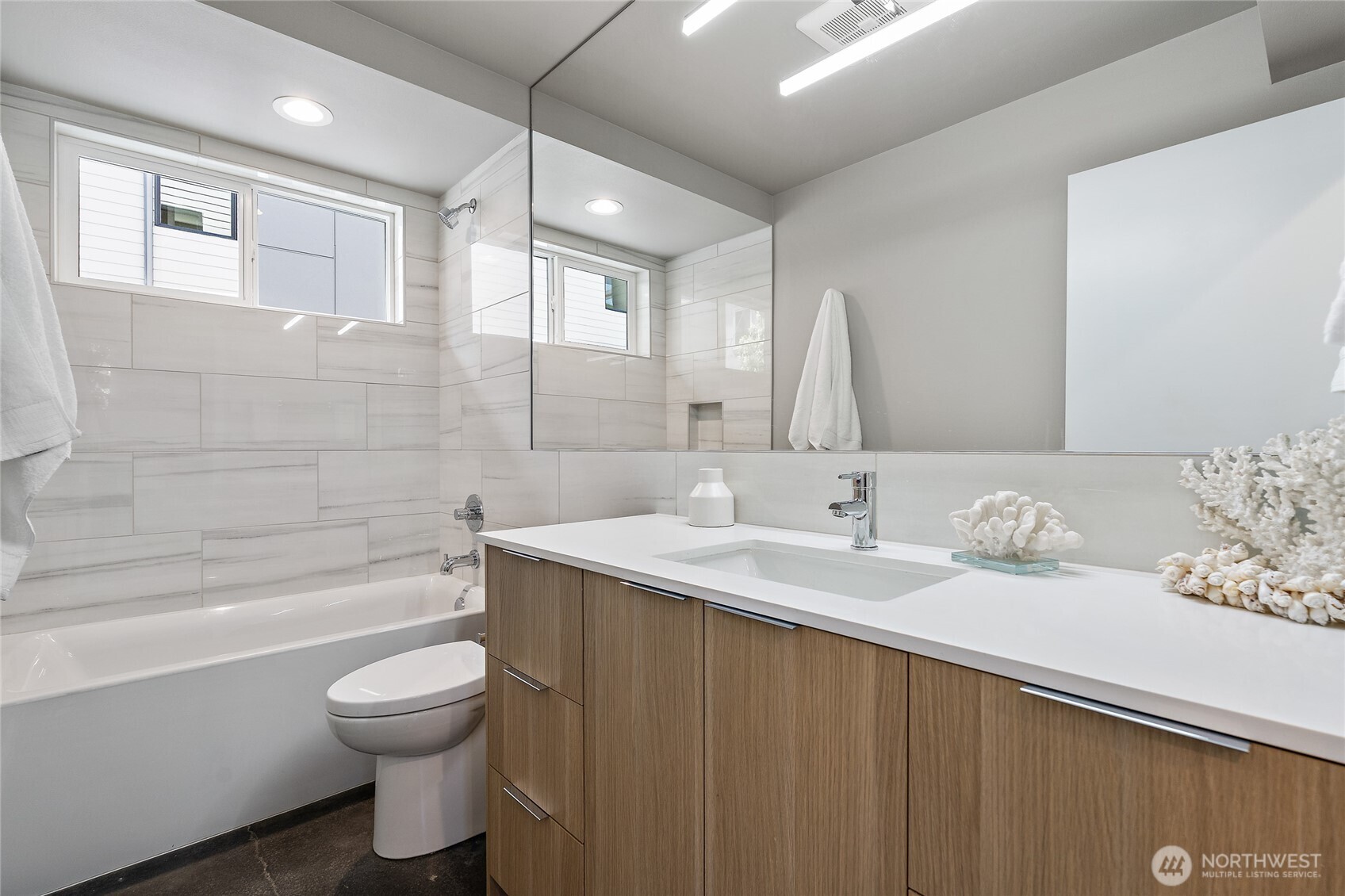 1801 Northwest 65th Street, Unit C Seattle, WA 98117 - Photo 5 of 40 a bathroom with a granite countertop sink toilet and shower