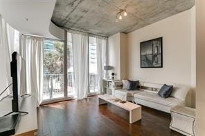 a living room with furniture and large windows