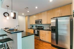 5925 Almeda Road, Unit 10808 Houston, TX 77004 - Photo 4 of 9 a kitchen with stainless steel appliances granite countertop a sink a stove and a refrigerator