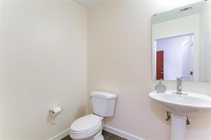5925 Almeda Road, Unit 10808 Houston, TX 77004 - Photo 7 of 9 a bathroom with a toilet sink and mirror