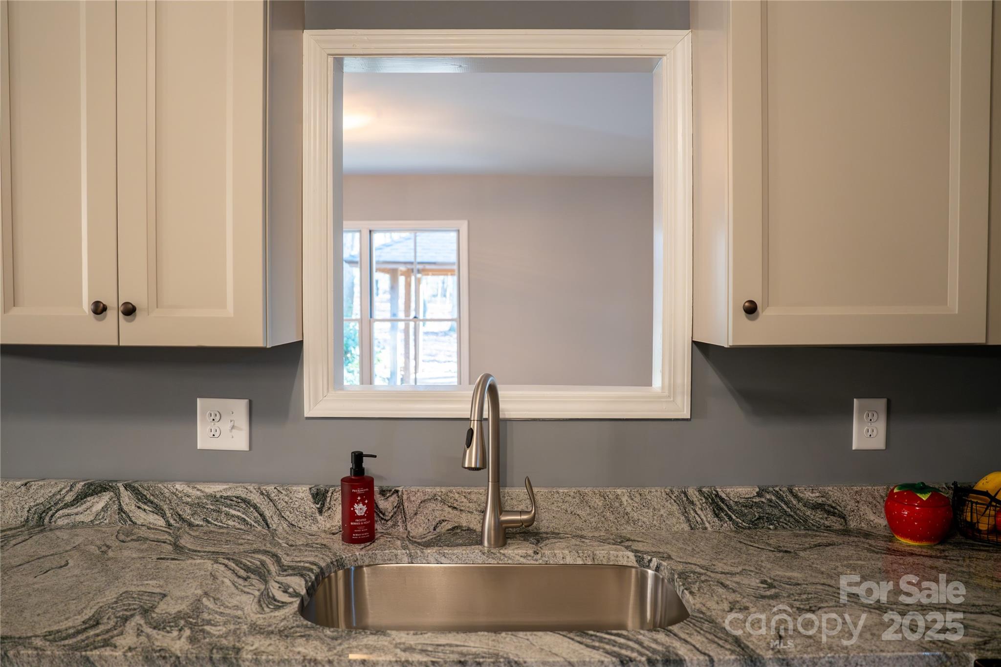 44585 Baldwin Road New London, NC 28127 - Photo 13 of 47 a kitchen with granite countertop white cabinets and a sink