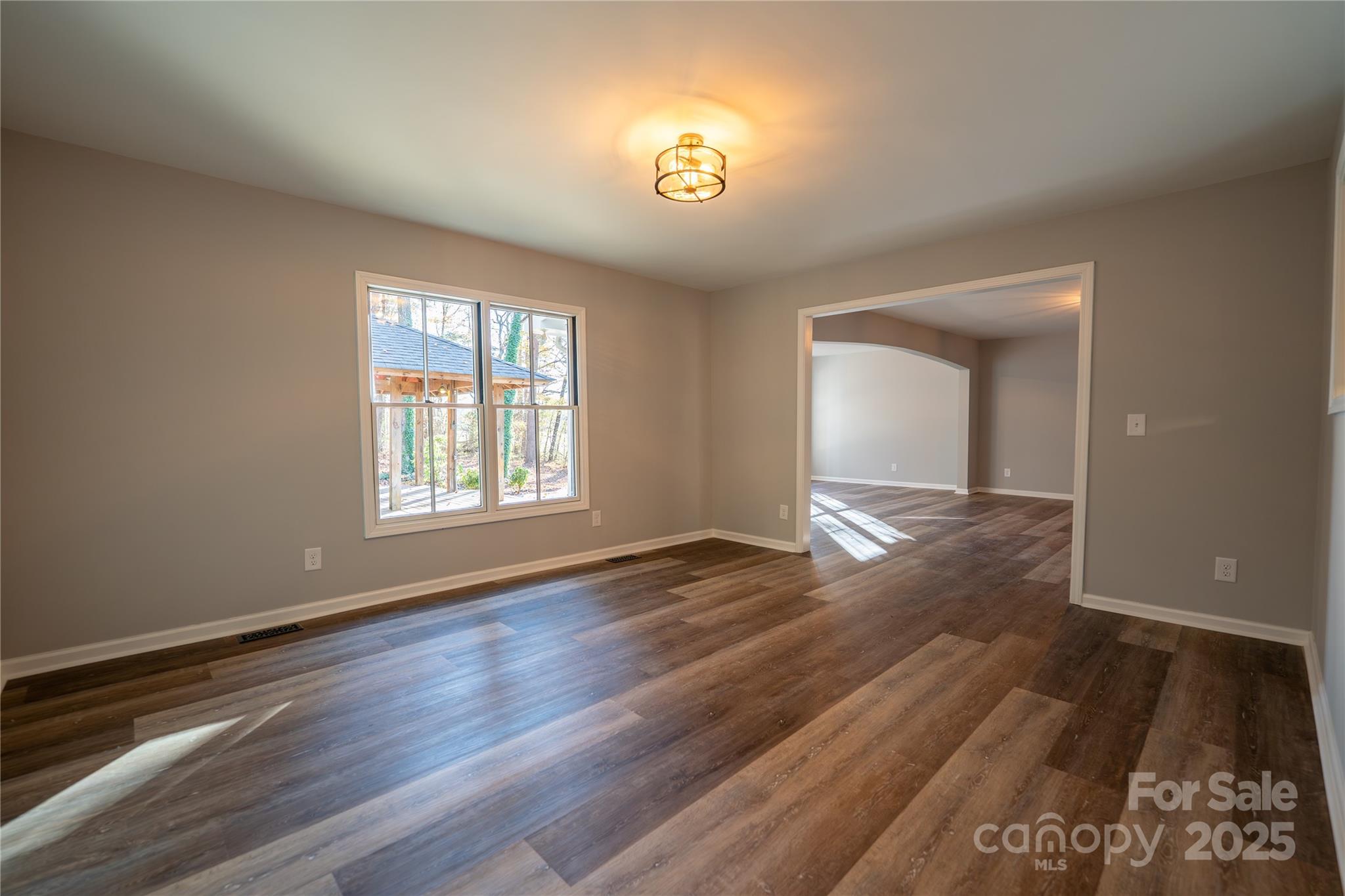 44585 Baldwin Road New London, NC 28127 - Photo 18 of 47 a view of an empty room with wooden floor and a window