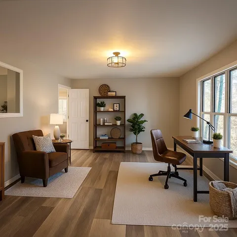 a view of a livingroom with workspace and a couch