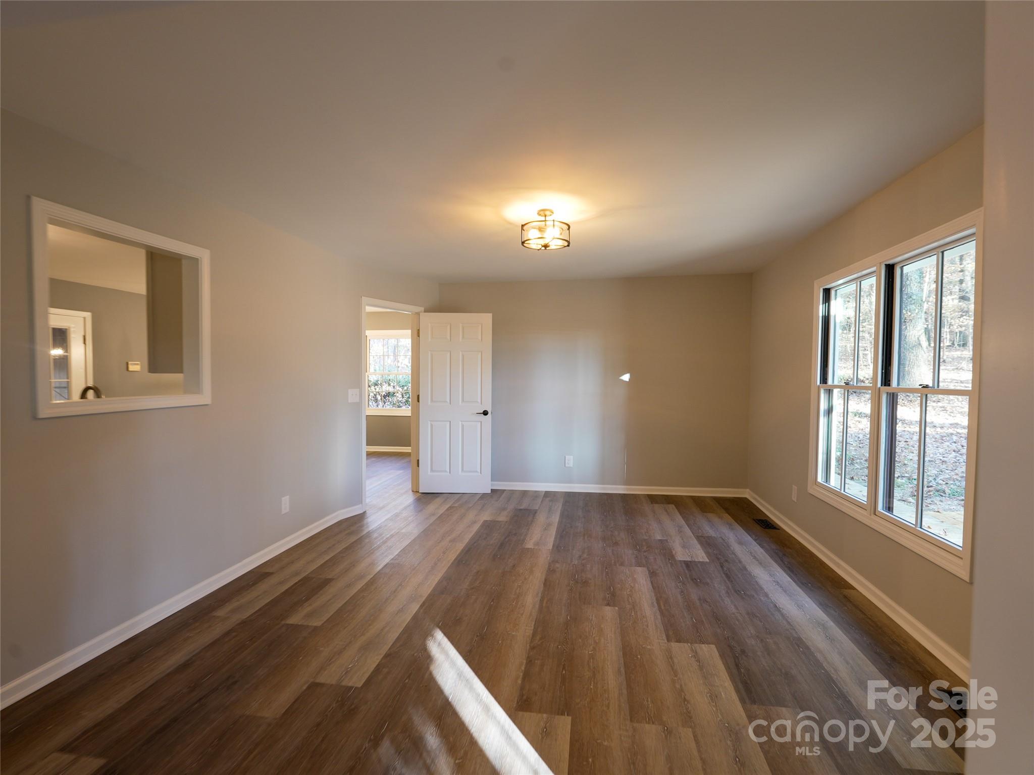 44585 Baldwin Road New London, NC 28127 - Photo 20 of 47 an empty room with wooden floor and windows