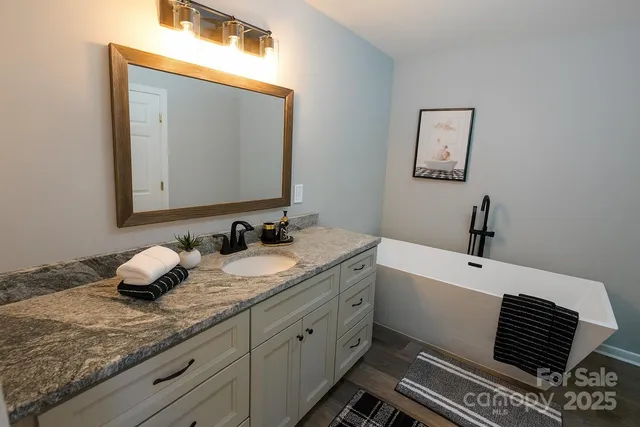 a bathroom with a double vanity sink and mirror