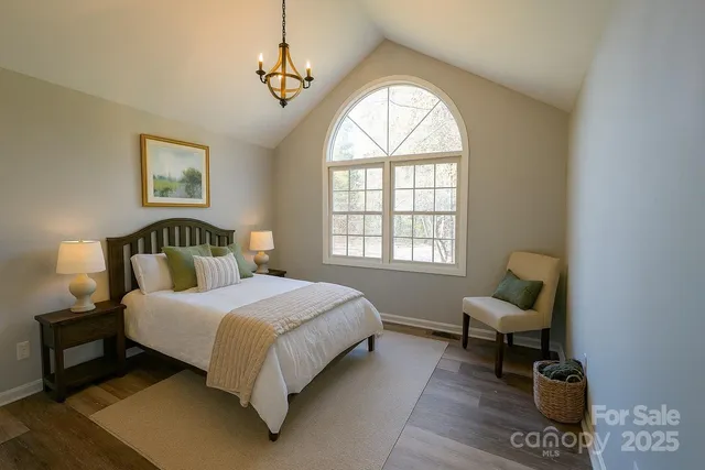 a spacious bedroom with a bed and a window