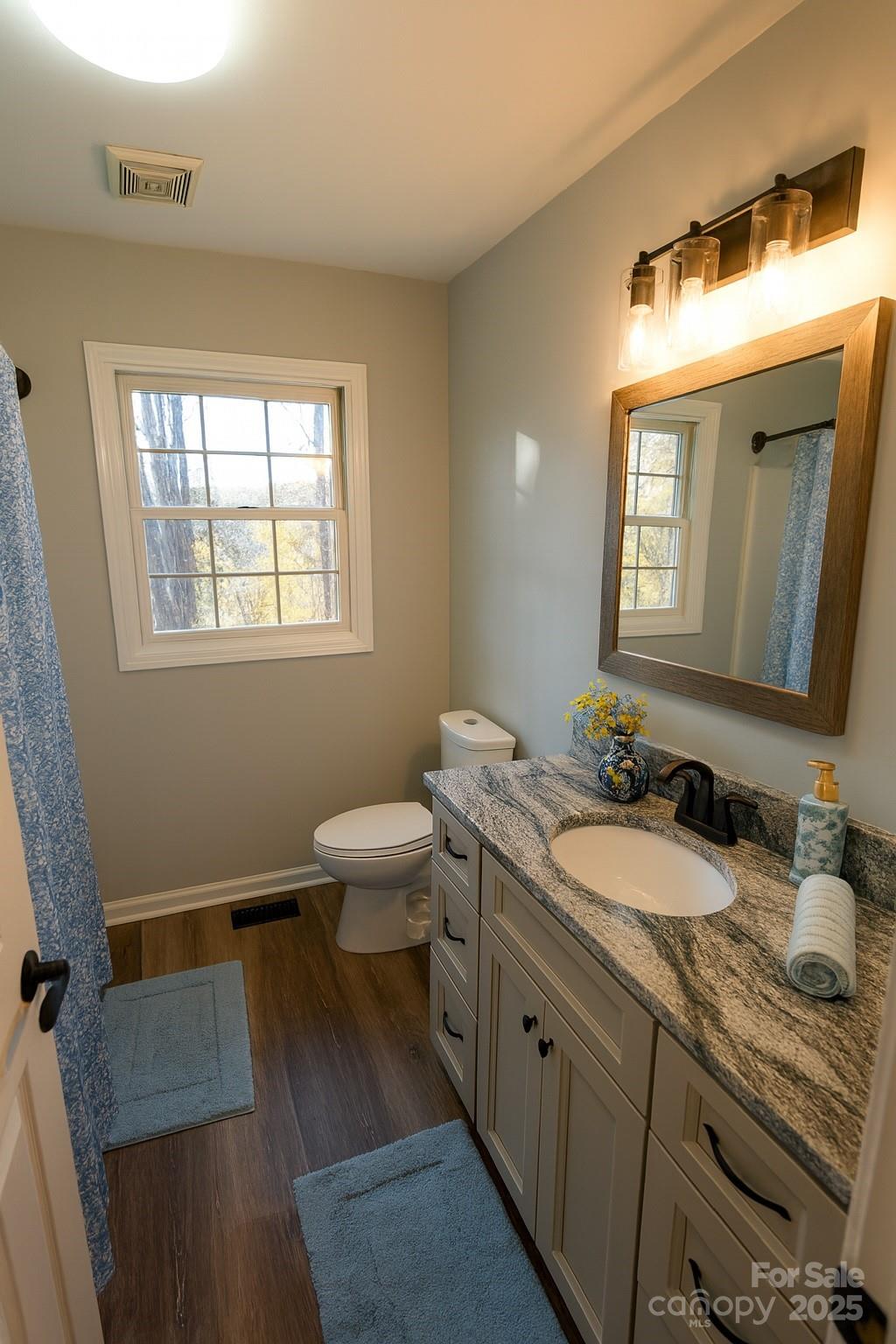 44585 Baldwin Road New London, NC 28127 - Photo 30 of 47 a spacious bathroom with a double vanity sink a mirror and a toilet