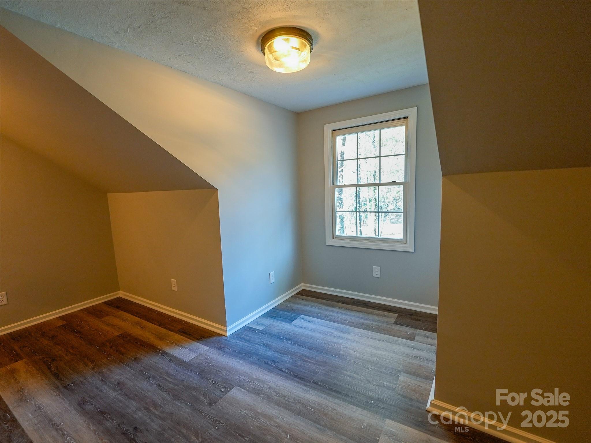 44585 Baldwin Road New London, NC 28127 - Photo 34 of 47 an empty room with wooden floor and windows