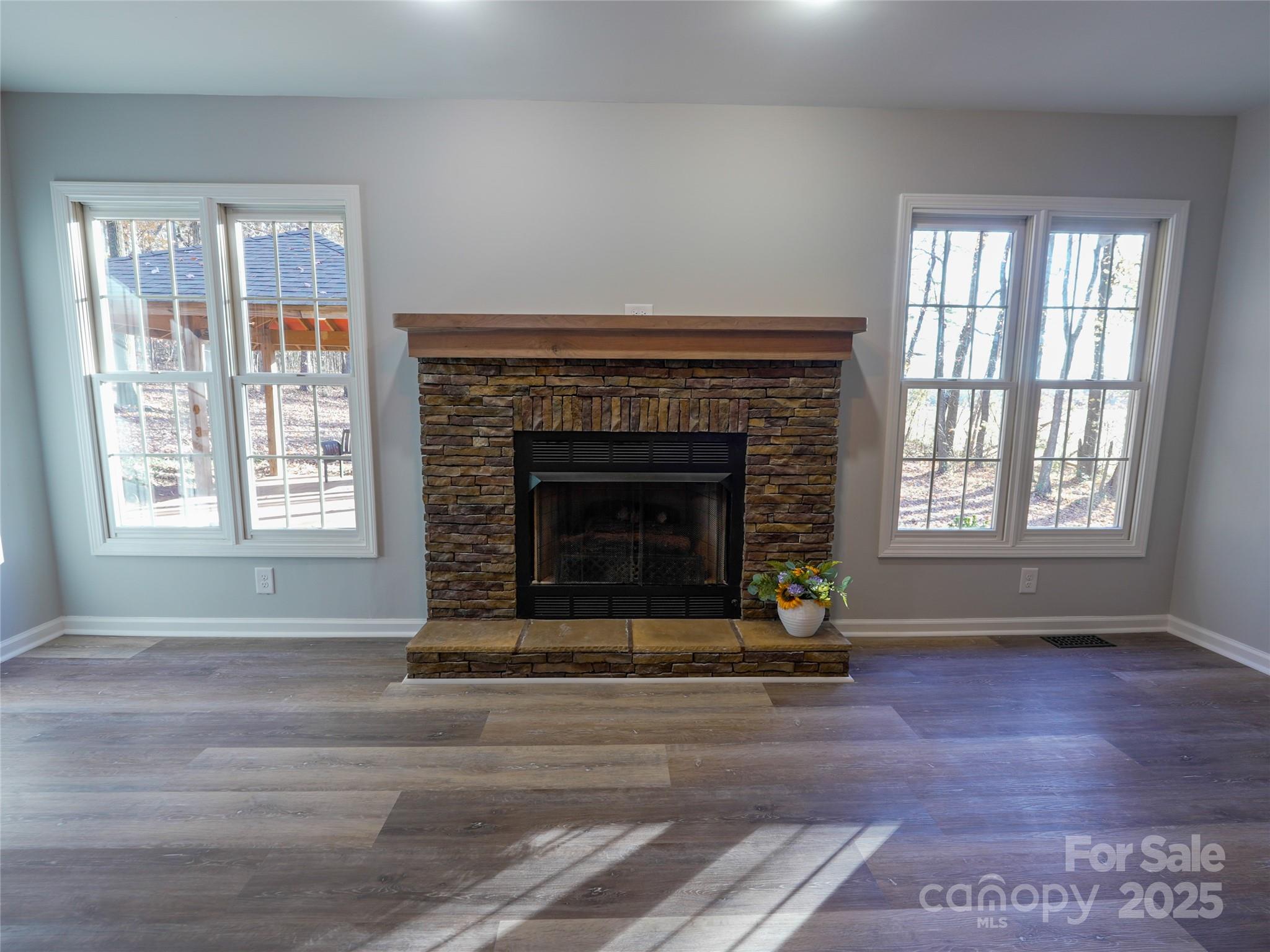 44585 Baldwin Road New London, NC 28127 - Photo 8 of 47 a living room with a fireplace and windows