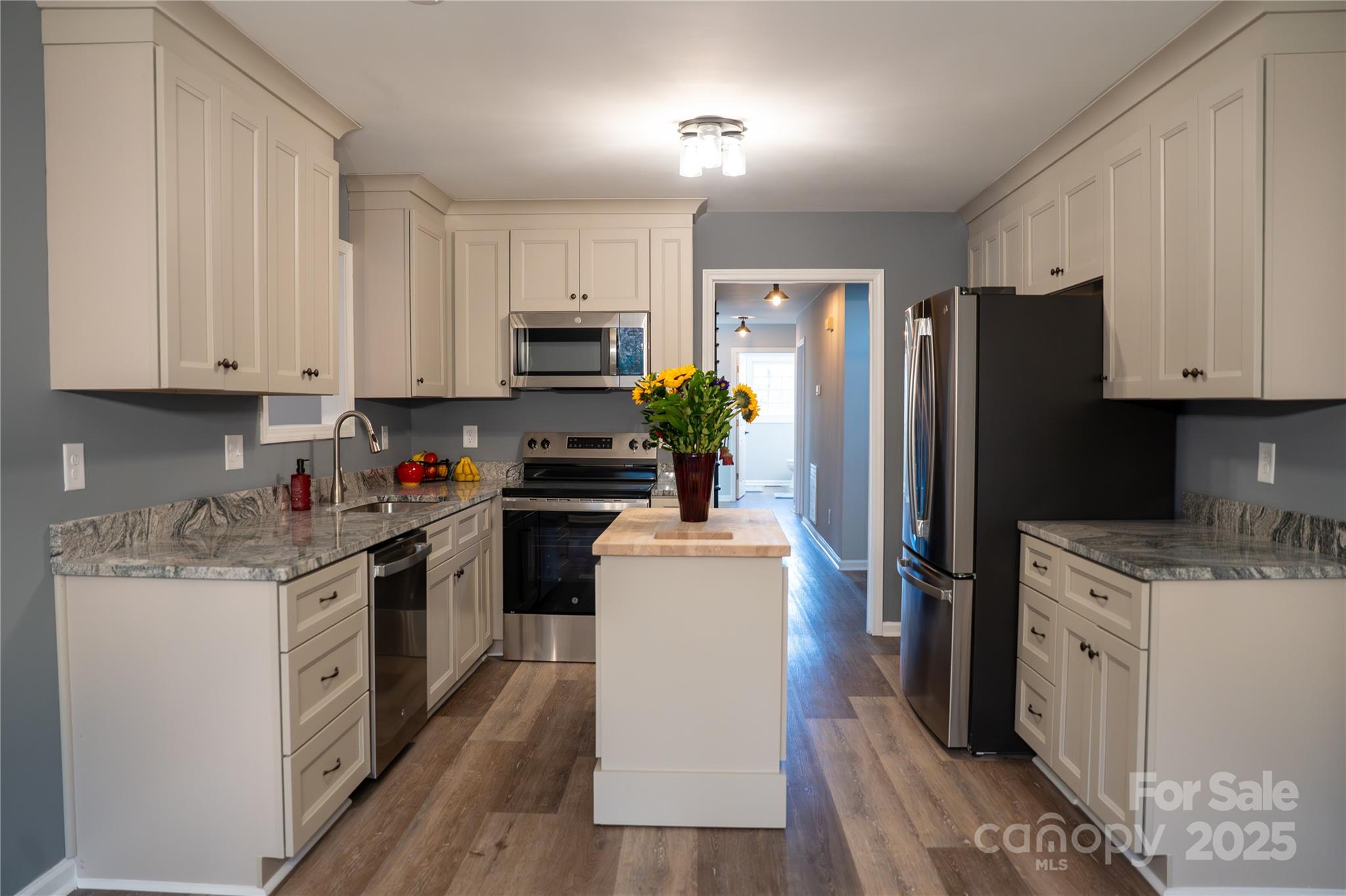 44585 Baldwin Road New London, NC 28127 - Photo 10 of 47 a kitchen with stainless steel appliances granite countertop a refrigerator stove microwave and sink