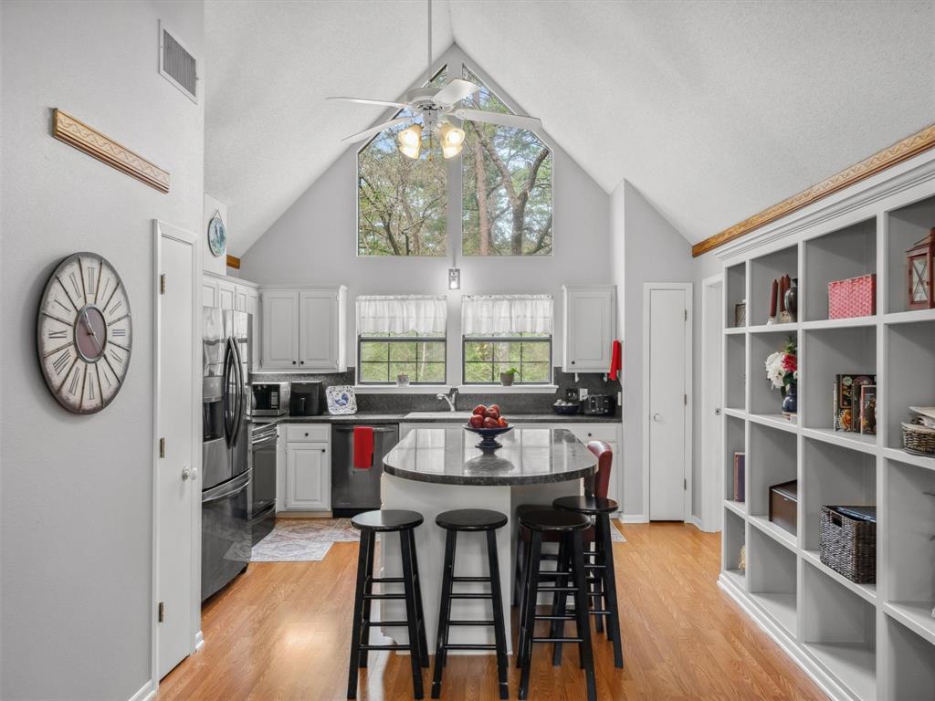 299 Lamplight Path Holly Lake Ranch, TX 75765 - Photo 12 of 40 a view of a dining room with furniture window and wooden floor